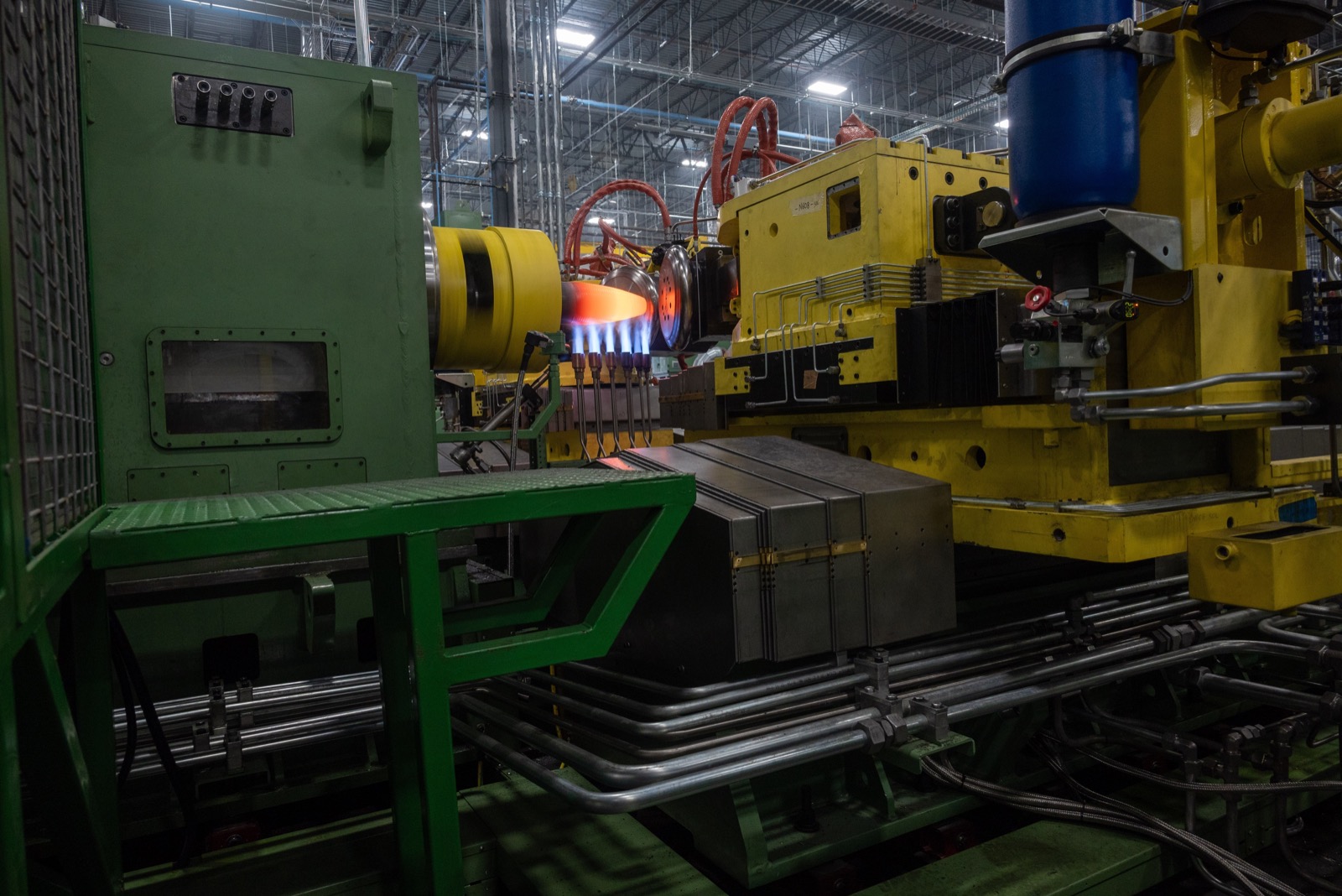 A heated metal projectile body inside production equipment at the Universal Artillery Projectile Lines facility in Mesquite, Texas